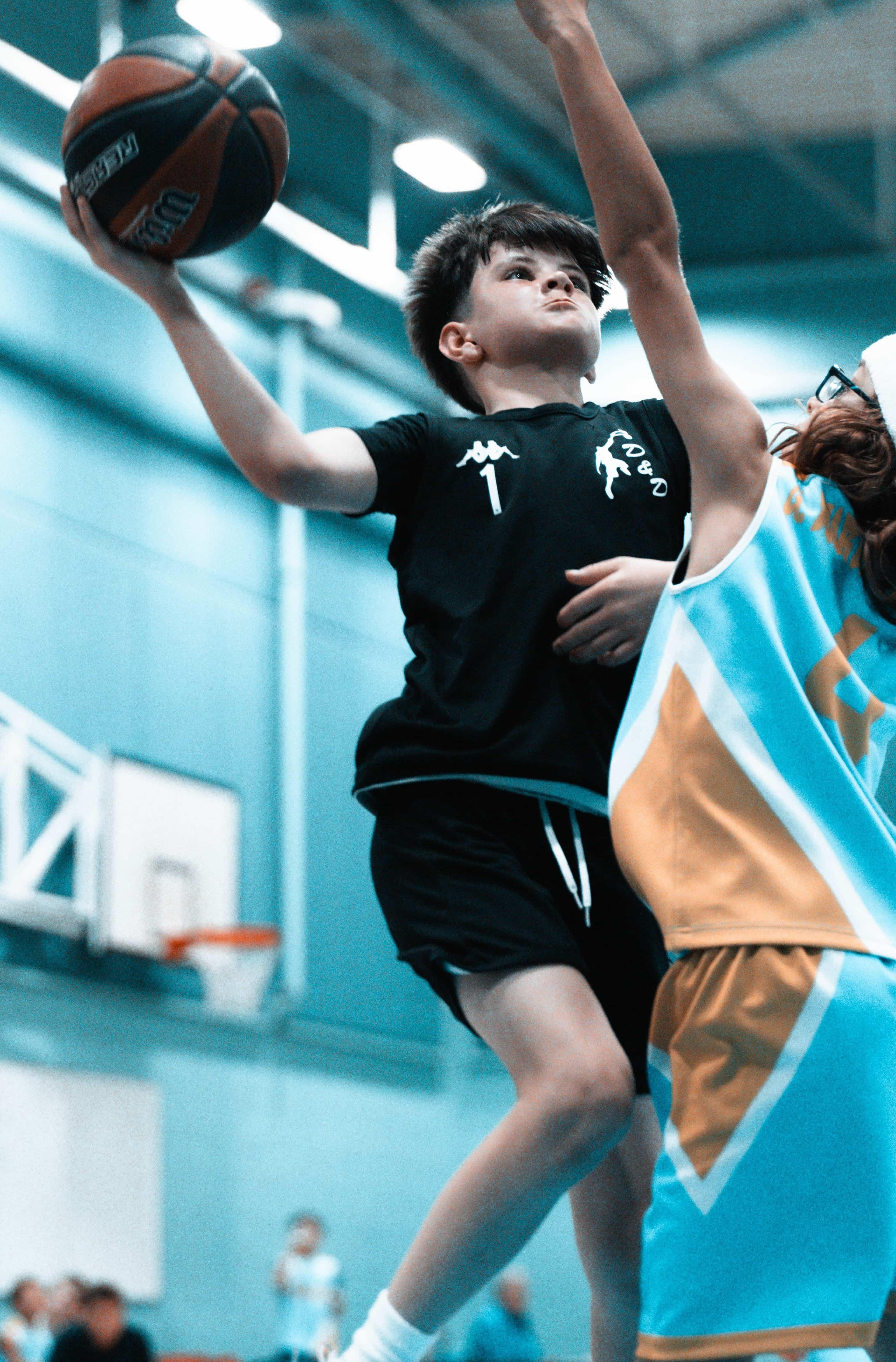 Boy Shooting the ball in a Basketball Game